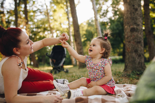 istock Young  mother playing with her daughter in the park 904220080