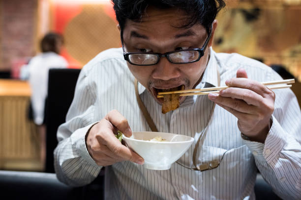 istock portrait man eating grilled. 904223332