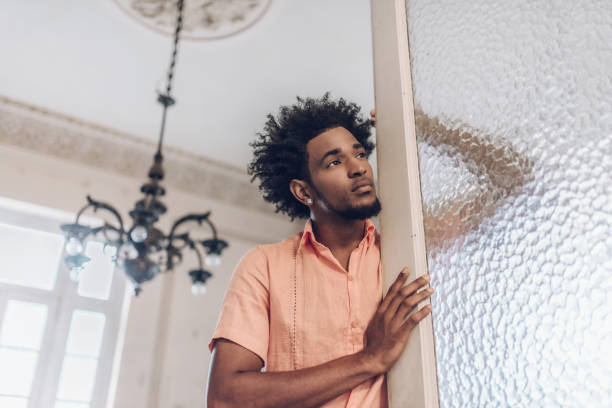 istock handsome pensive afro-caribbean cuban man leaning at door 904223534