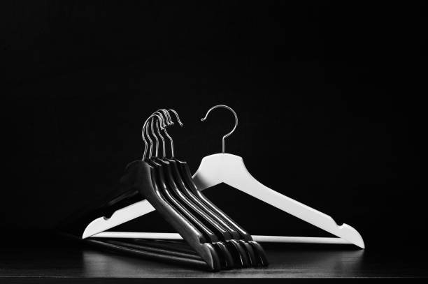istock White hanger and a few black hangers, background, abstract 904224548