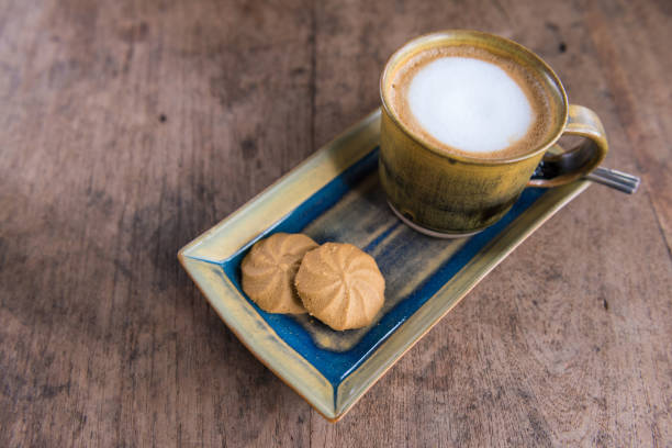 istock Cappuccino cup with cookies on wooden table 904225000