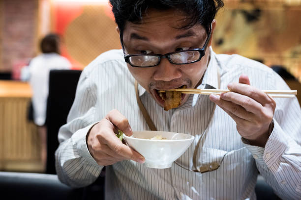 istock portrait man eating grilled. 904225394
