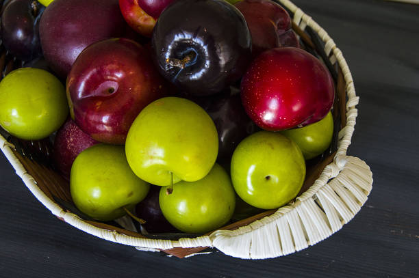 istock green sour plum, sour summer fruity in a fruit basket, 904231112