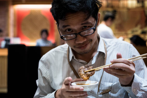 istock portrait man eating grilled. 904231756