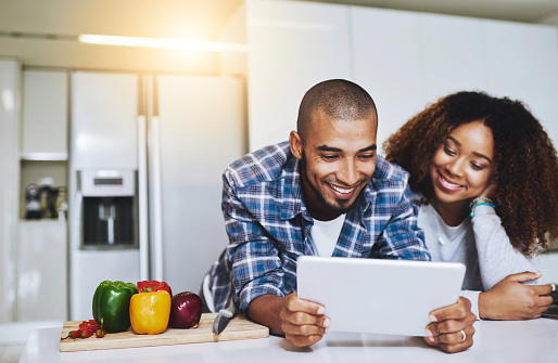 Shot of a young couple using a tablet together at home