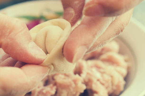 The process of making delicious home-made dumplings with meat.