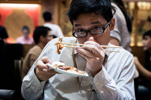 portrait man eating grilled.