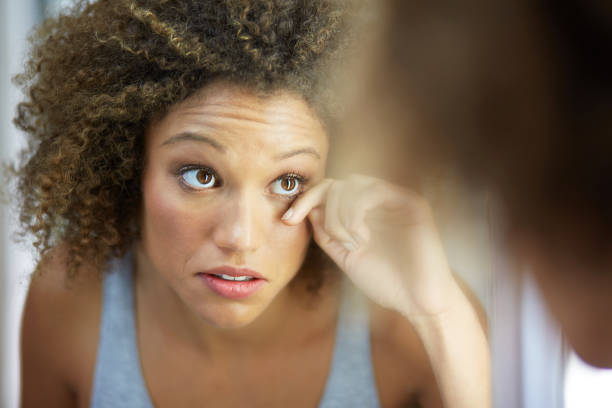 Pretty young woman in mirror checking make up