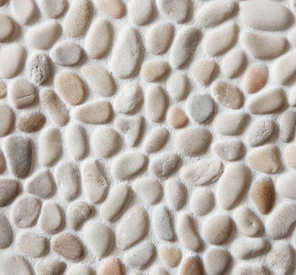 istock Fragment of the  wall is decorated with a small sea pebbles 904250368