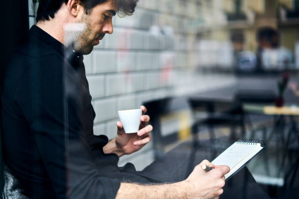 istock Cropped image of successful businessman working remote and creating new financial plan for company sitting in coffee shop interior and enjoying tasty espresso on promotion background for advertise 904256964
