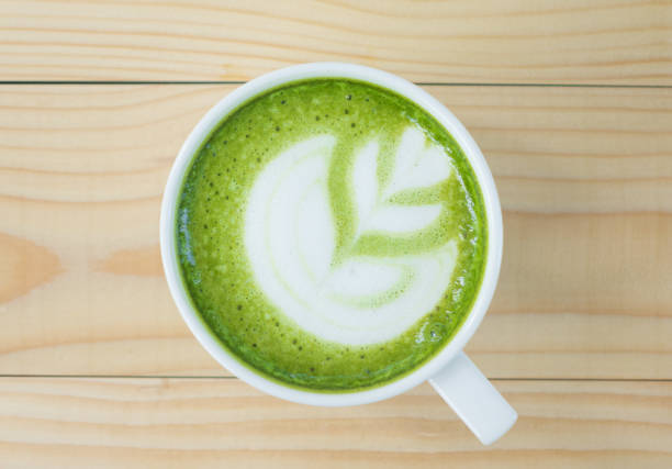 istock Hot art Green Tea Coffee in a cup on wooden table 904257334