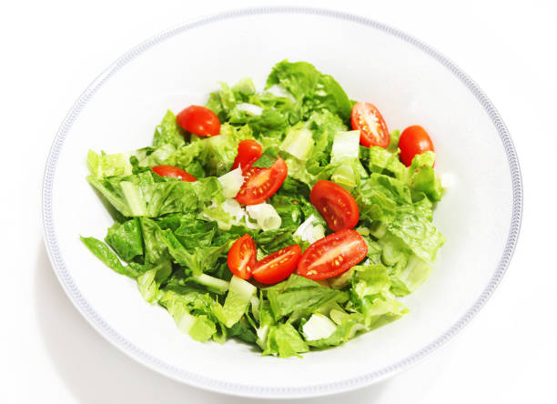 istock fresh salad with lettuce and tomatoes isolated on white 904257610