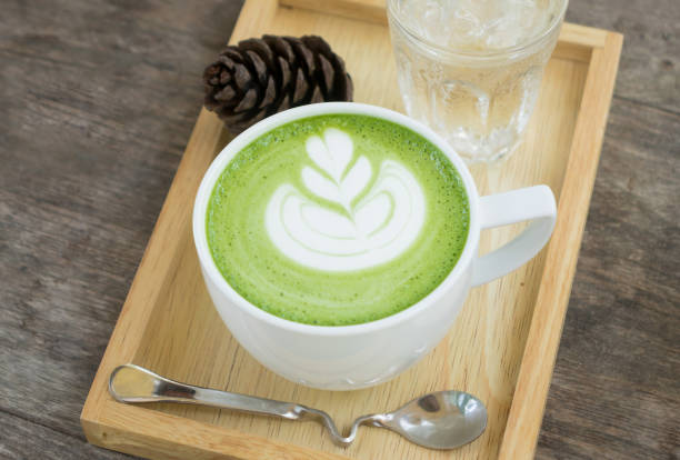 istock Hot art Green Tea Coffee in a cup on wooden table 904258368