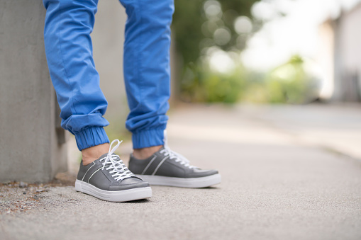 Man's feet in a modern, casual shoes.