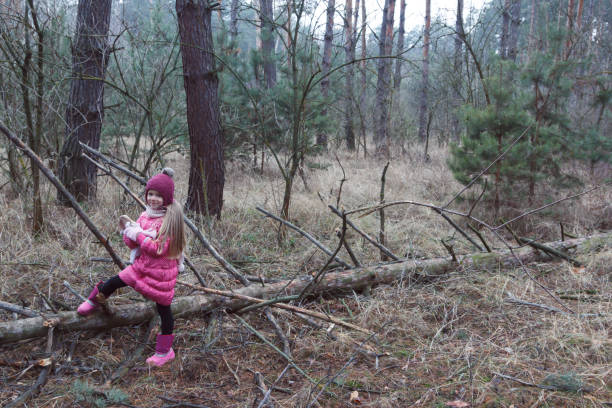istock The girl stands near the fallen tree. 904261248
