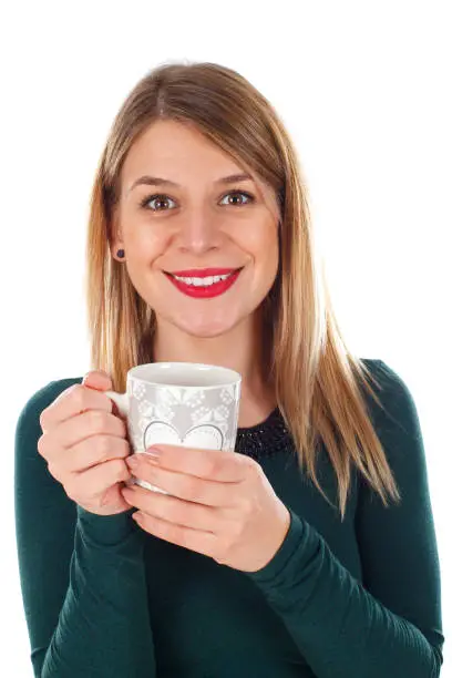 Portrait of a beautiful smiling woman holding a cup of tea