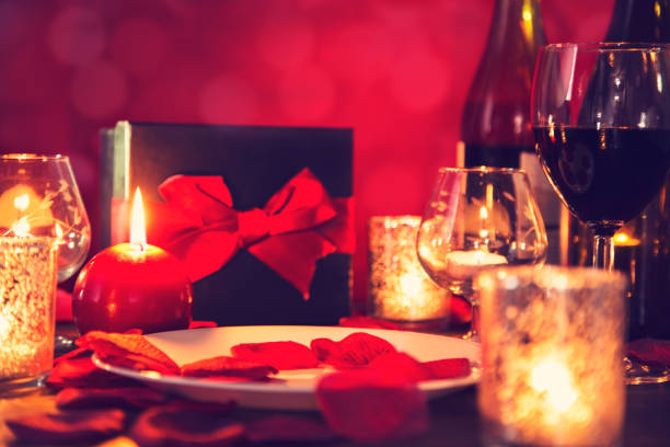 istock Valentine's Day romantic candlelight dinner with gift and wine. 904261710