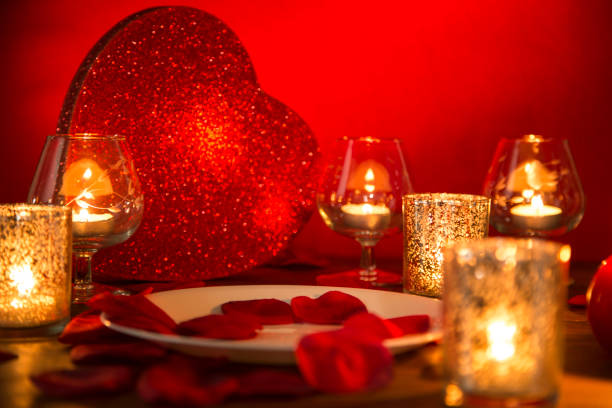istock Valentine's Day romantic candlelight dinner with heart and rose petals. 904263046