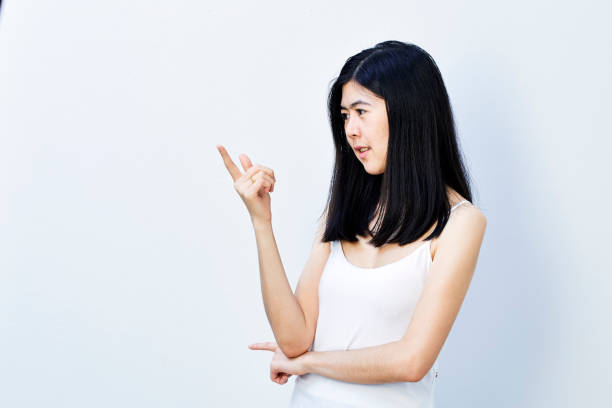 istock Young cute asian woman pointing 904265774
