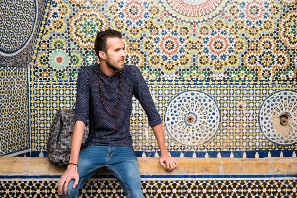 istock Young Muslim man sitting with traditional Moroccan decoration in background 904268520