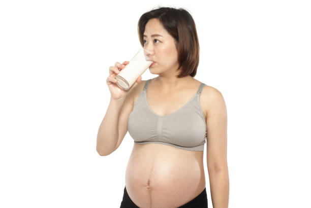 istock Pregnant woman drink milk on white 904268908
