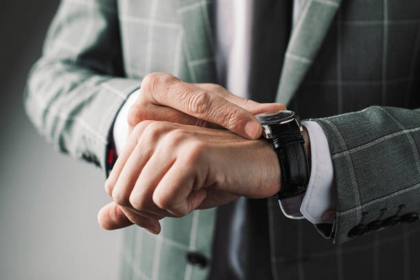 istock businessman adjusting his wristwatch 904269340