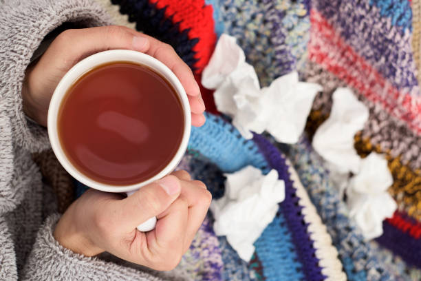 istock ill man warming up with a cup of tea 904269566