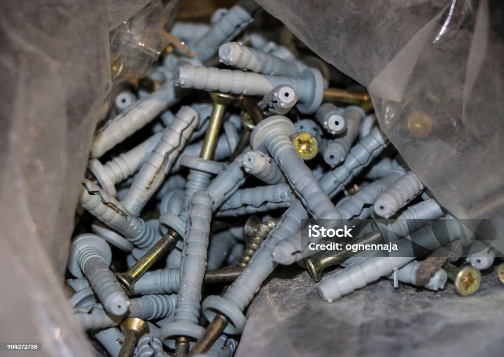 Long and short screws with sharp threads and round hats Bolt - Fastener Stock Photo