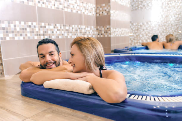 istock Young couple is relaxing in bubbling hot tub 904277702