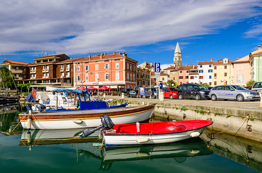 Izola, Slovenia - September 20, 2016: the scenic harbour with boats and brightly coloured houses on the waterfront in Izola.
