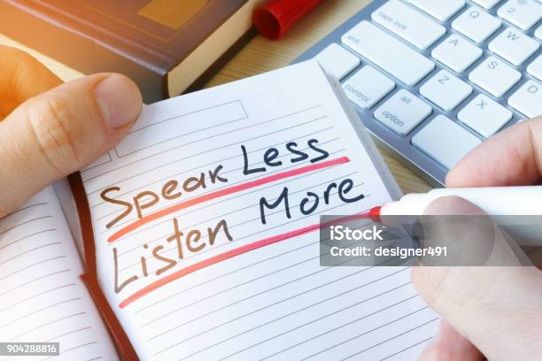Man Writing Quote Speak Less Listen More Stock Photo - Download Image Now - Listening, Efficiency, Business