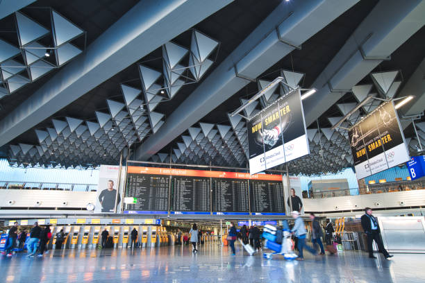 Frankfurt am Main, Germany - January 10, 2018: People in motion blur walking through the Departure Hall of Frankfurt Airport Terminal 1, largest Airport of Germany.