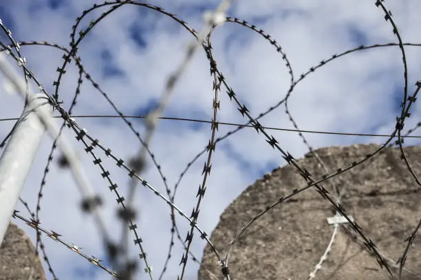 Photo of Abstract barbed wire detail of strong topwith  straight concrete walls of a submarine bunker in St Nazarre, France