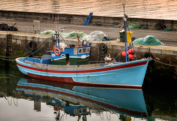 fishing boat reflected on sea at Kalamata port Peloponnese Greece