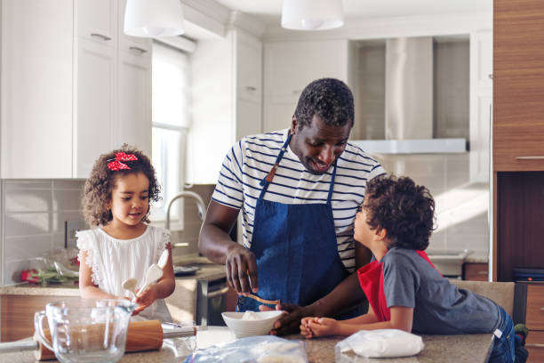 istock Father cooking with kids 904293344