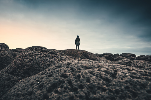 Woman standing on beach in west part of Iceland and enjoying the view.