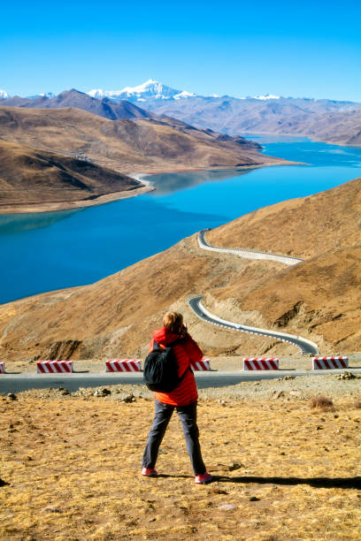 istock Female hiker photographing in Tibet 904297198