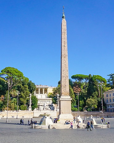 The Egypitan Obelisk of Ramesses II   in the centre of the Piazza del Popolo and the hill that leads to Pincio Gardens in Rome, Italy