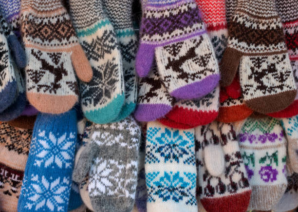 Mittens on the winter Christmas market. Multi-colored knitted woolen mittens. Christmas gift or souvenir.