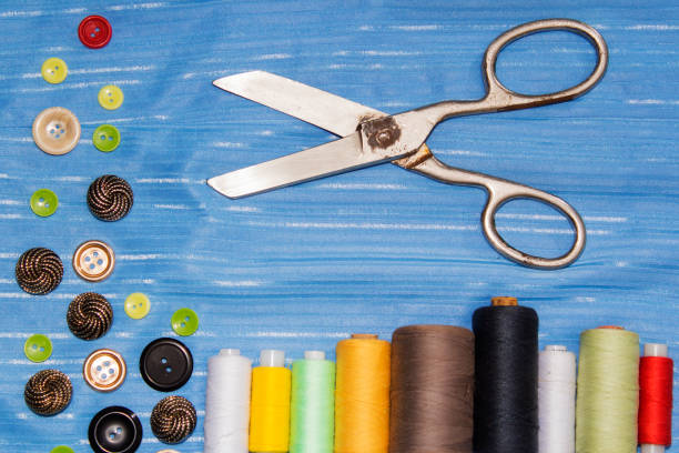 istock Background of sewing: scissors, thread, needles, measuring tape close up top view. 904311358