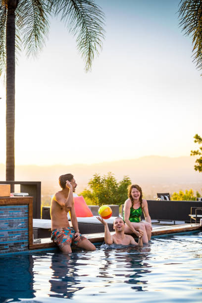 istock Men and Woman Playing in Swimming Pool 904312444