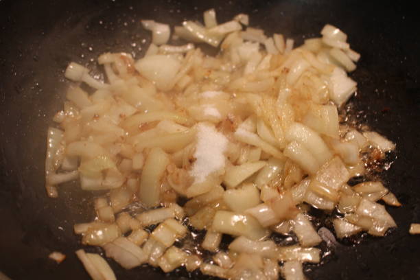 istock Caramelized onions being made in a large wok type pan 904313074