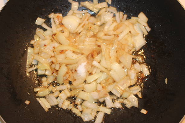 istock Caramelized onions being made in a large wok type pan 904313080