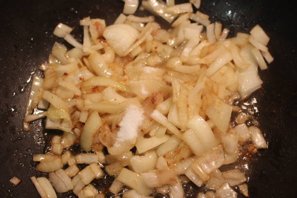 istock Caramelized onions being made in a large wok type pan 904313082
