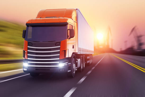 semi-truck on a highway in sunset - speed horizontal commercial land vehicle automobile industry imagens e fotografias de stock