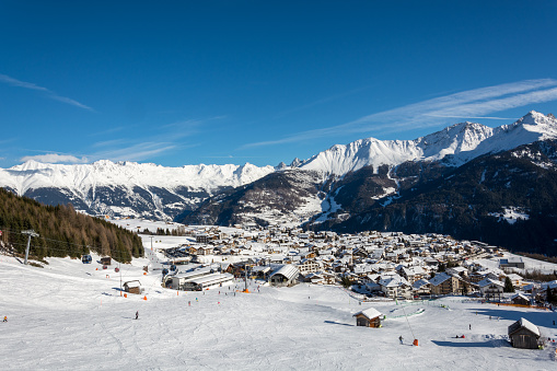 View on the village Fiss in the ski resort Serfaus Fiss Ladis in Austria with snowy mountains and blue sky