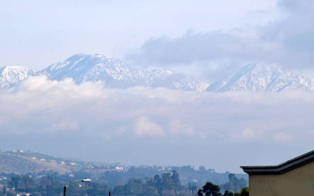 istock Snowy Peaks Tower Above the Clouds 904321762