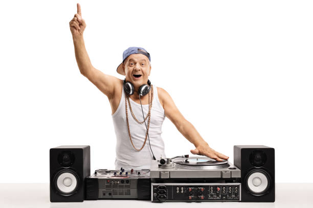 istock Cheerful old DJ playing music on  a turntable and holding his finger up 904321974