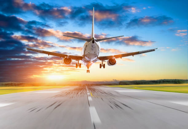istock Passenger airplane landing at sunset on a runway. 904324326