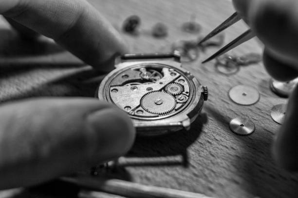 istock watch maker is repairing a vintage automatic watch. 904324704